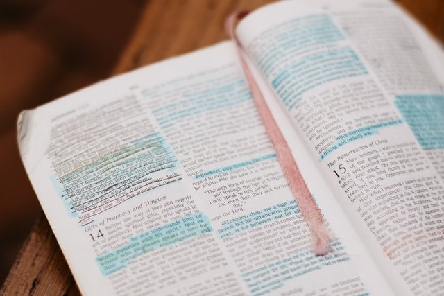 Photo of a Bible with a pink ribbon and some verses marked with blue highliter