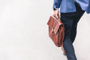 man with briefcase walking away from the camera