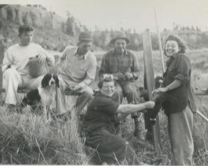 Five people with dog, guns and dead pheasant