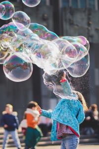 girl blowing bubbles