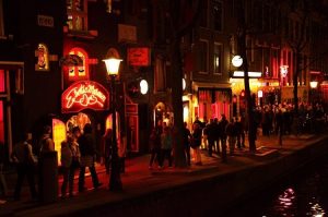 People walking in front of Exotica Museum on Amsterdam street in Red Light District