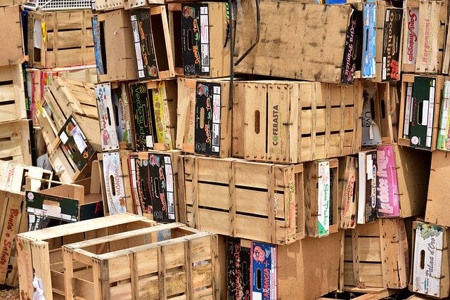 wooden cartons of books stacked haphazardly