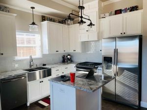 Updated older kitchen but with low cupboards that leave about inches headroom for counters. 