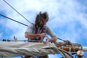 Sailor tending a sail