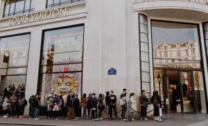 People lined up to enter a Louis Vuitton store