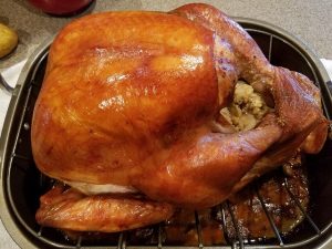 stuffed turkey on roasting pan