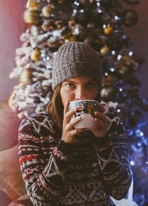 Sweater girl drinking from mug